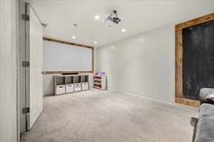 Home theater featuring light carpet and recessed lighting
