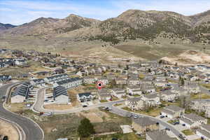 Aerial view of property and surrounding area with nearby area and a mountainous background