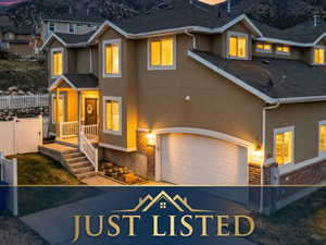 Traditional-style home featuring brick siding, stucco siding, a mountain view, and a porch