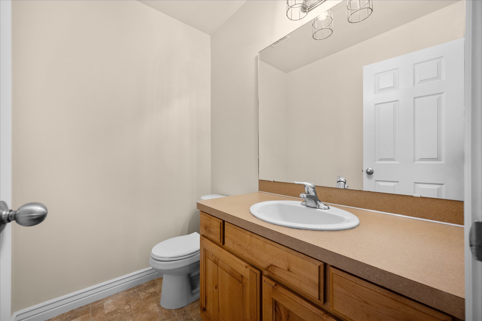 Half bath featuring vanity and toilet