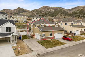 View of front of home featuring a residential view, stucco siding, driveway, and a garage