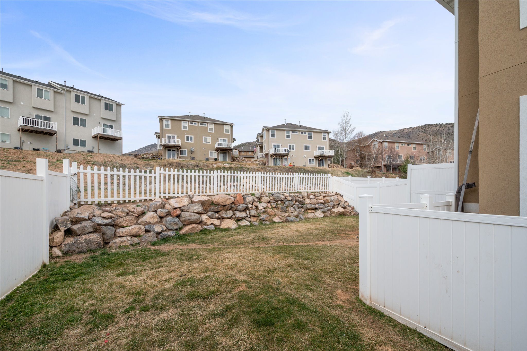 Fenced backyard with a residential view