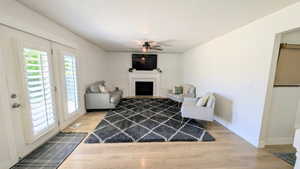 Living area featuring light wood-finish flooring and white walls