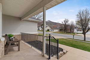 Porch featuring a residential view and a mountain view