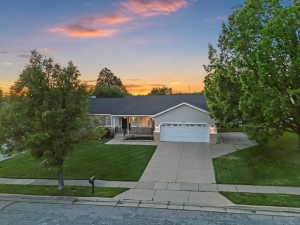 Ranch-style residence featuring a prominent two-car garage, concrete driveway, and a welcoming front entrance