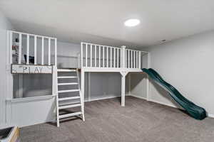 Unfurnished bedroom featuring light carpet and baseboards