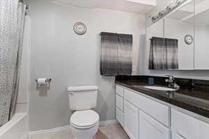 Full bathroom with vanity, light tile patterned floors, and shower / tub combo