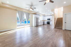 Unfurnished living room featuring ceiling fan, recessed lighting, and light wood-type flooring