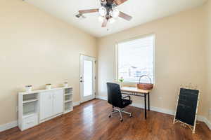 Office area with dark wood-style floors and ceiling fan