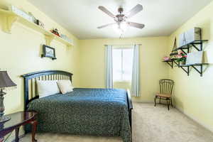 Bedroom with light carpet and ceiling fan