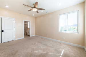 Unfurnished bedroom featuring connected bathroom, light carpet, ceiling fan, and recessed lighting
