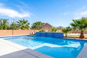View of pool featuring a fenced backyard and patio surround