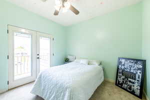 Bedroom with light colored carpet, access to exterior, and ceiling fan