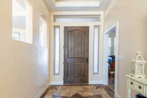 Entryway with inlaid floor details and plenty of natural light