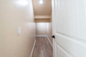 Corridor featuring baseboards and light wood finished floors