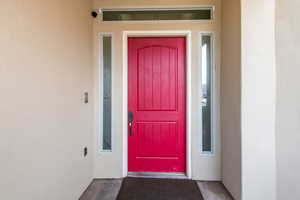 Entrance to property featuring stucco siding