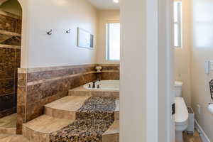 Full bath featuring a bath and toilet
