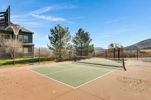 View of tennis court featuring community basketball court and a mountain view