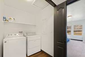 Laundry area with separate washer and dryer and dark wood-style flooring