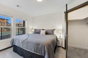 Carpeted bedroom featuring baseboards