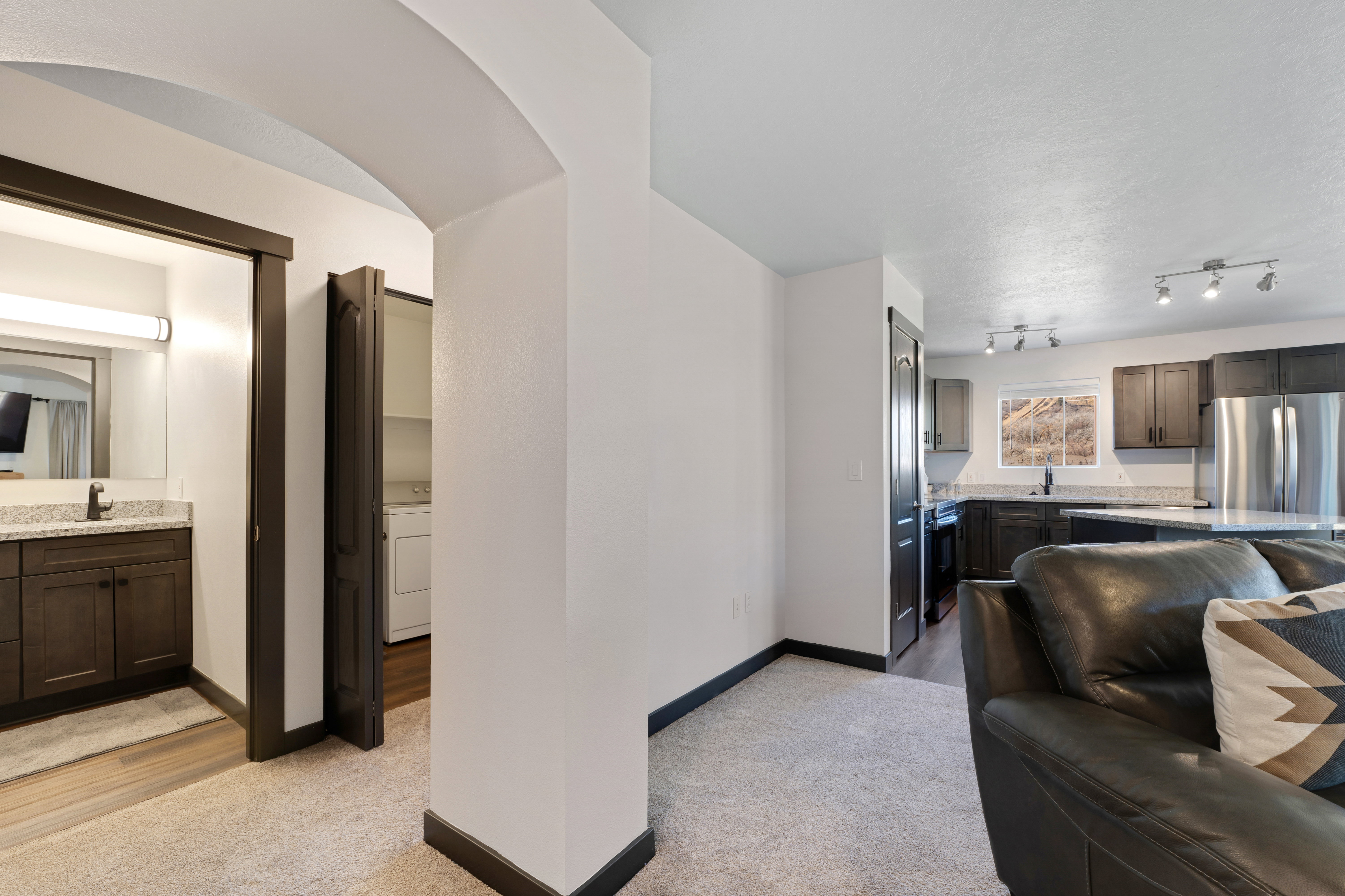 Living room featuring light carpet and washer / clothes dryer