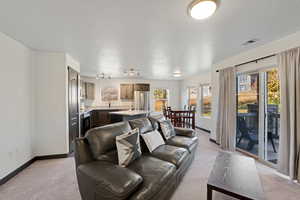 Living room with light carpet and a textured ceiling