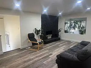 Living area with wood finished floors, a fireplace, and recessed lighting