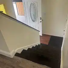 Stairs with baseboards and wood finished floors