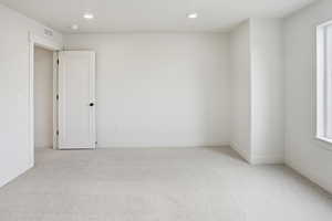Spare room with light carpet and recessed lighting