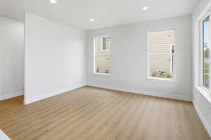 Spare room featuring light wood-type flooring and recessed lighting