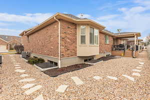 View of home's exterior featuring a wooden deck and brick siding