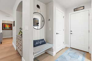 Entryway with light wood-style floors and baseboards