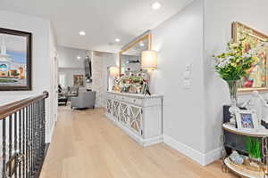 Hall featuring light wood-style floors and recessed lighting