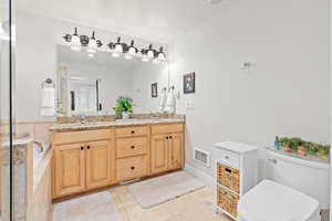 Bathroom featuring double vanity and light tile patterned flooring