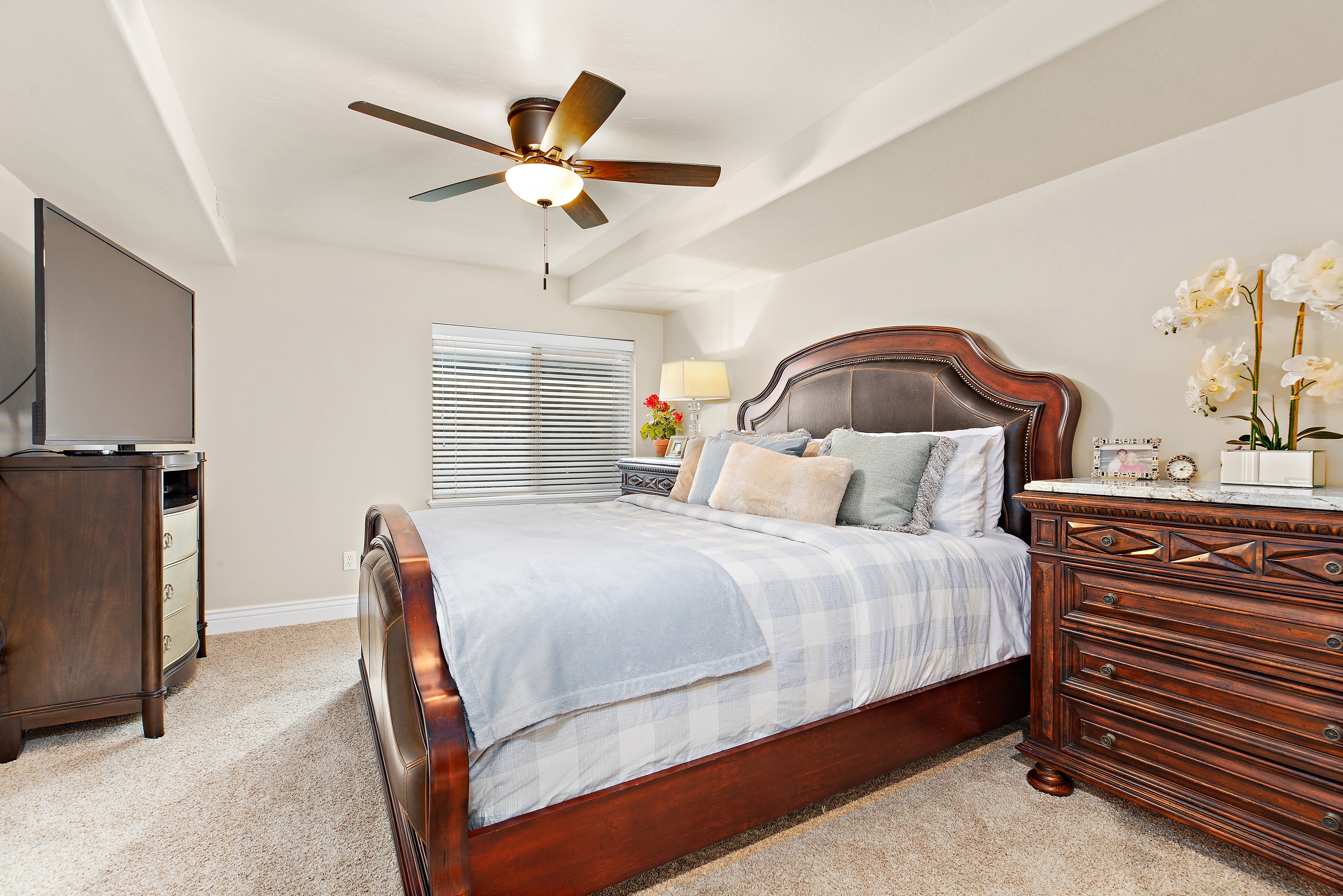 Bedroom featuring light colored carpet and ceiling fan