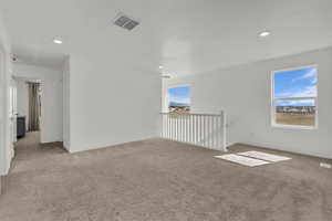 Spare room with light carpet and recessed lighting