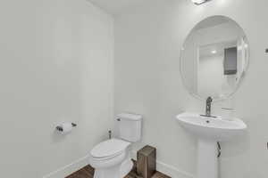 Bathroom with baseboards and dark wood-style floors