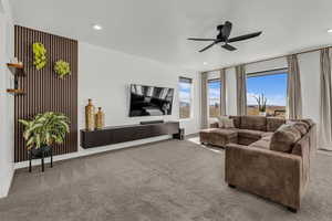 Living room with light colored carpet, a ceiling fan, and recessed lighting