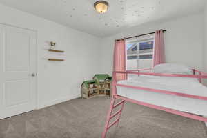 Bedroom featuring light colored carpet and baseboards