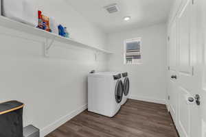 Laundry area featuring dark wood-style floors and washer and dryer