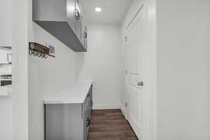 Mudroom featuring dark wood-style floors and recessed lighting