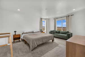 Carpeted bedroom with recessed lighting