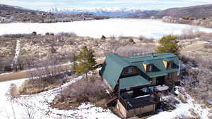 Snowy aerial view with a water and mountain view