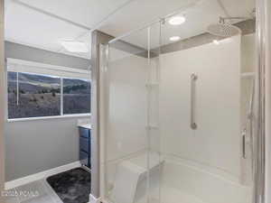 Bathroom with vanity, a stall shower, and light tile patterned floors