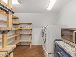 Laundry room featuring dark wood finished floors and washing machine and dryer