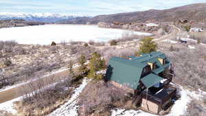 Snowy aerial view featuring a mountain view