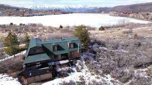 Snowy aerial view with a water and mountain view