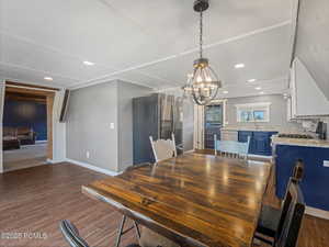 Dining space with wood tiled floors and hanging lights