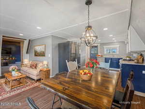 Virtually Staged Dining room featuring dark wood-style flooring and recessed lighting