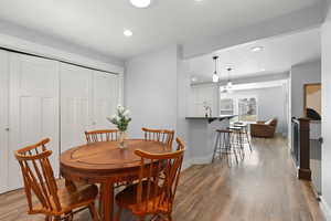 Dining area featuring light wood finished floors and recessed lighting